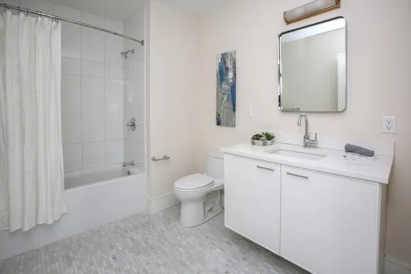 a bathroom with a sink toilet and shower