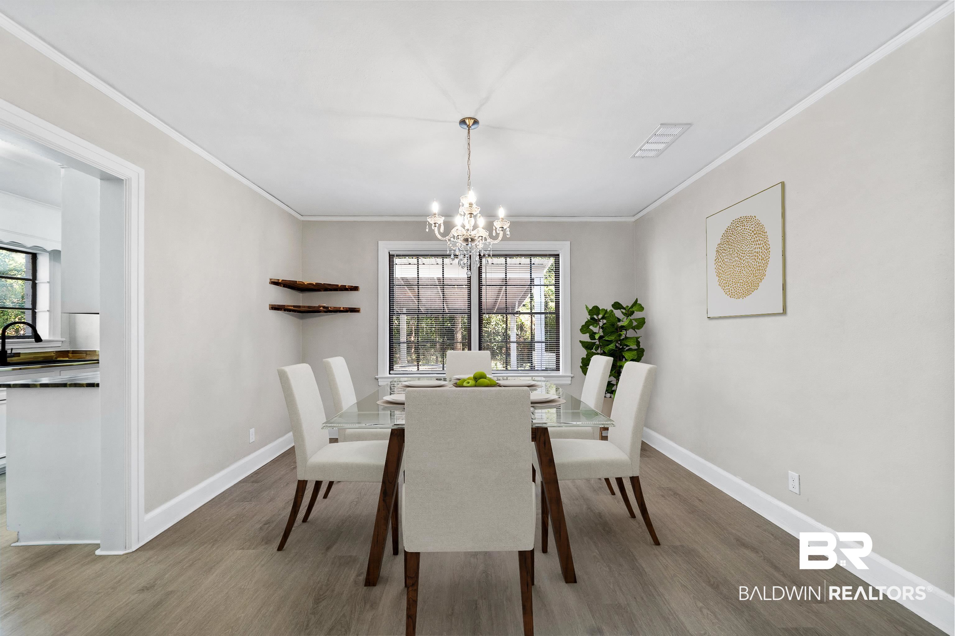 611 Morgan Avenue Mobile, AL 36606 - Photo 8 of 24 Dining area featuring hardwood / wood-style floors, sink, an inviting chandelier, and crown molding