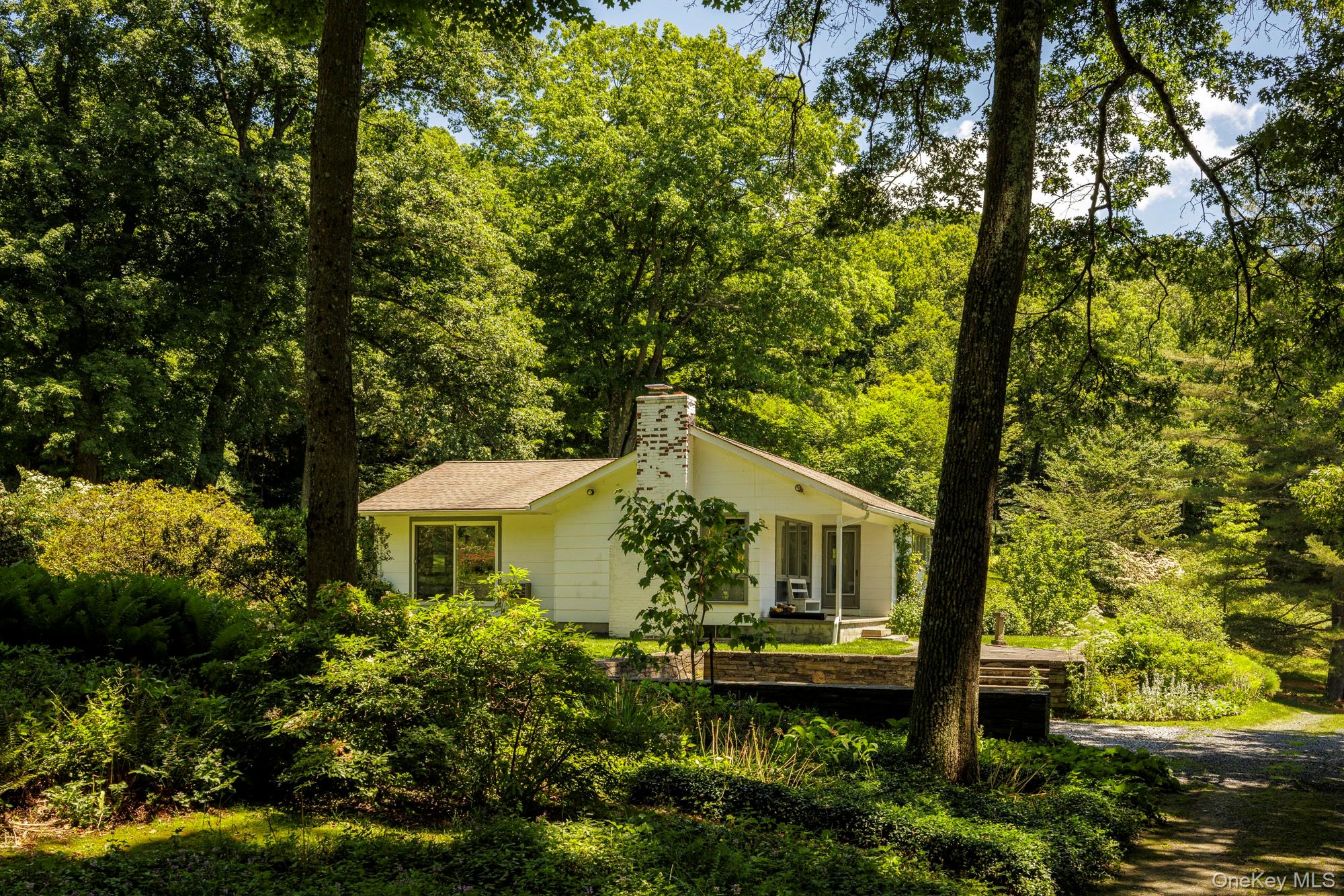 447 Butts Hollow Road Dover Plains, NY 12522 - Photo 3 of 27 a front view of a house with garden