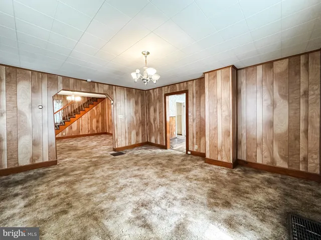 a kitchen with stainless steel appliances kitchen island granite countertop a refrigerator a sink dishwasher a stove and white cabinets with wooden floor