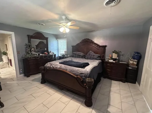a bedroom with a bed and a large mirror