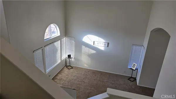 an empty room with fan and windows