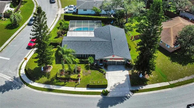 an aerial view of a house with a yard and garden