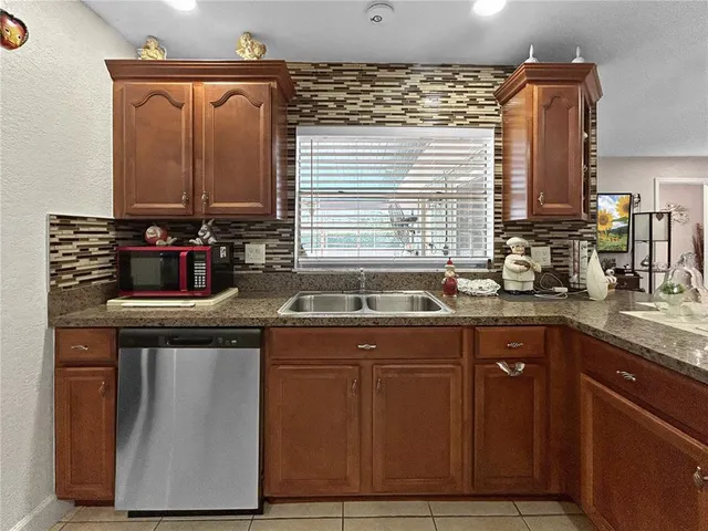 a kitchen with granite countertop a sink and cabinets