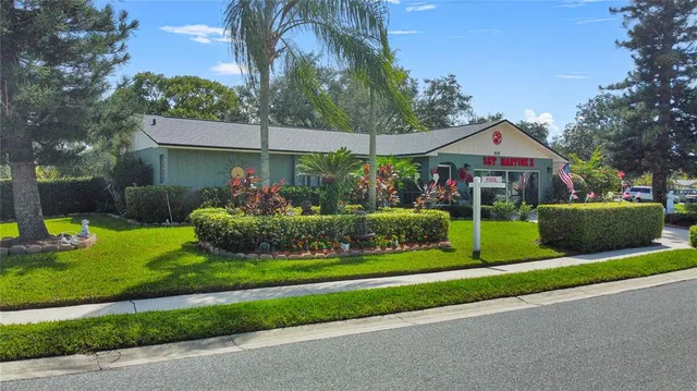 a front view of a house with a yard table and chairs