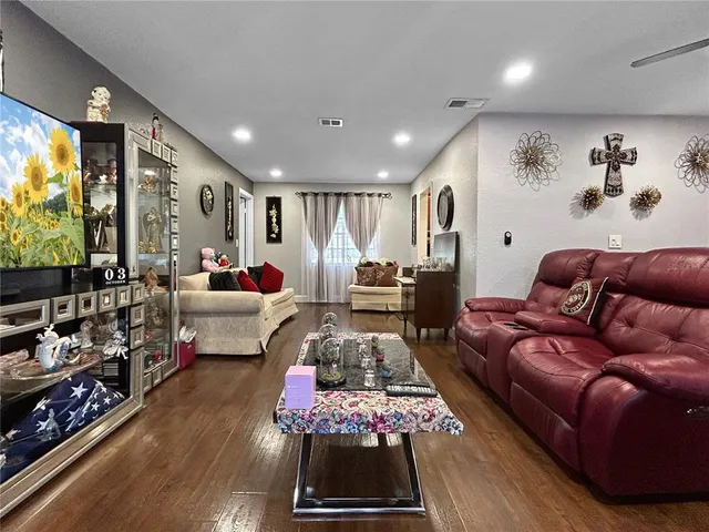 a living room with furniture a rug and a large window