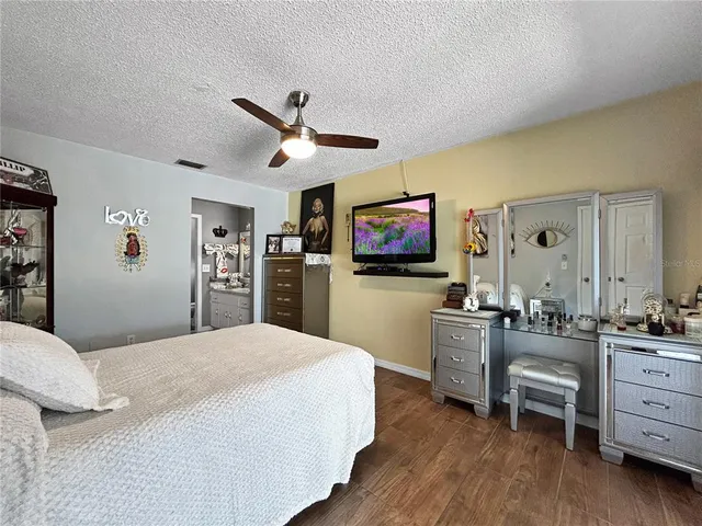 a bathroom with a granite countertop sink a toilet and shower