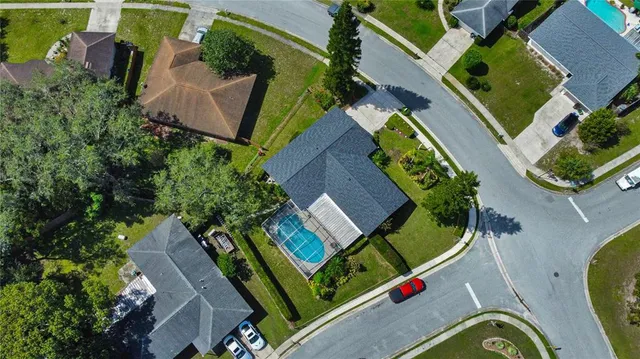 an aerial view of a house with a swimming pool