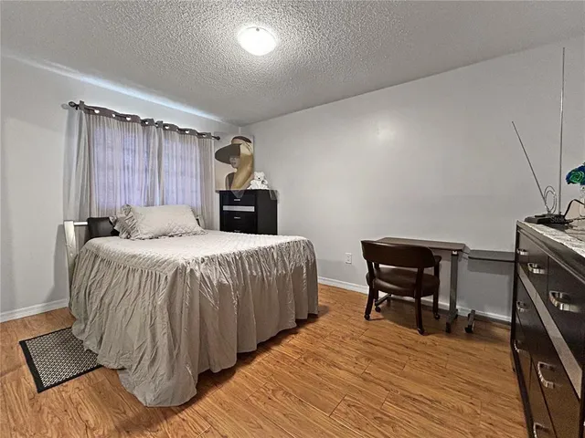 a living room with pool table and a large window with pool view