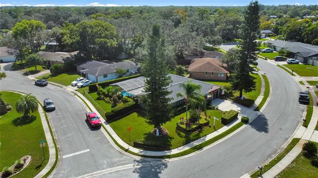 an aerial view of a house with a swimming pool patio and mountain view