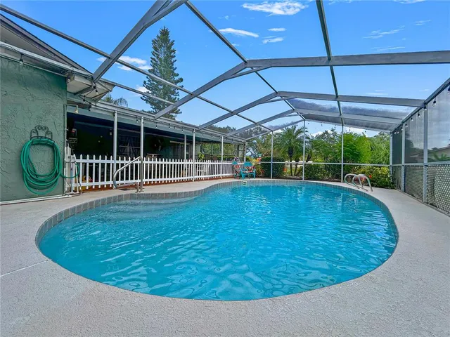a view of a backyard with a swimming pool