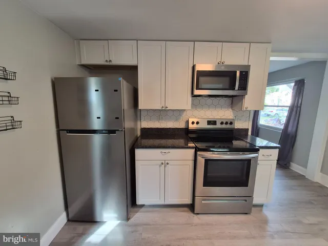 a kitchen with a refrigerator stove and microwave