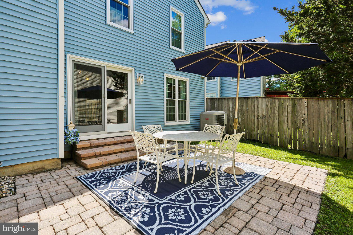 14822 Rose Trellis Place Silver Spring, MD 20906 - Photo 46 of 65 a patio with a patio table and chairs