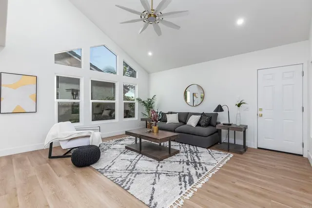 a living room with furniture and wooden floor