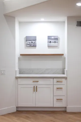 a large kitchen with stainless steel appliances a lot of counter space and wooden floor