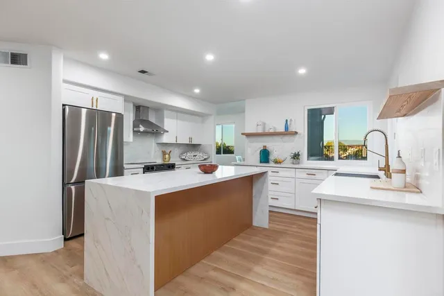 a kitchen with a sink stove and cabinets