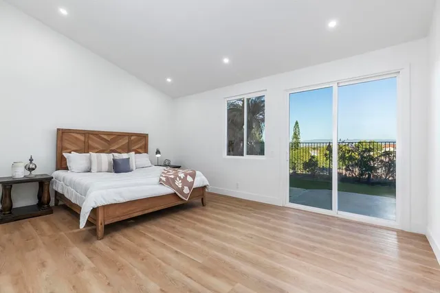 a bedroom with a bed and painting on the wall