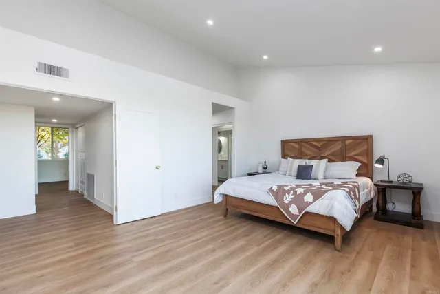 a bed room with a bed and wooden floor