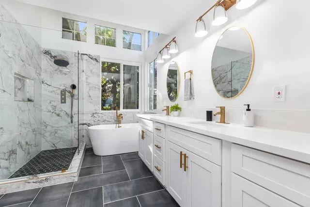 a white bath tub sitting in front of a window