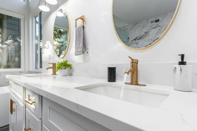 a bathroom with a sink a toilet and a mirror