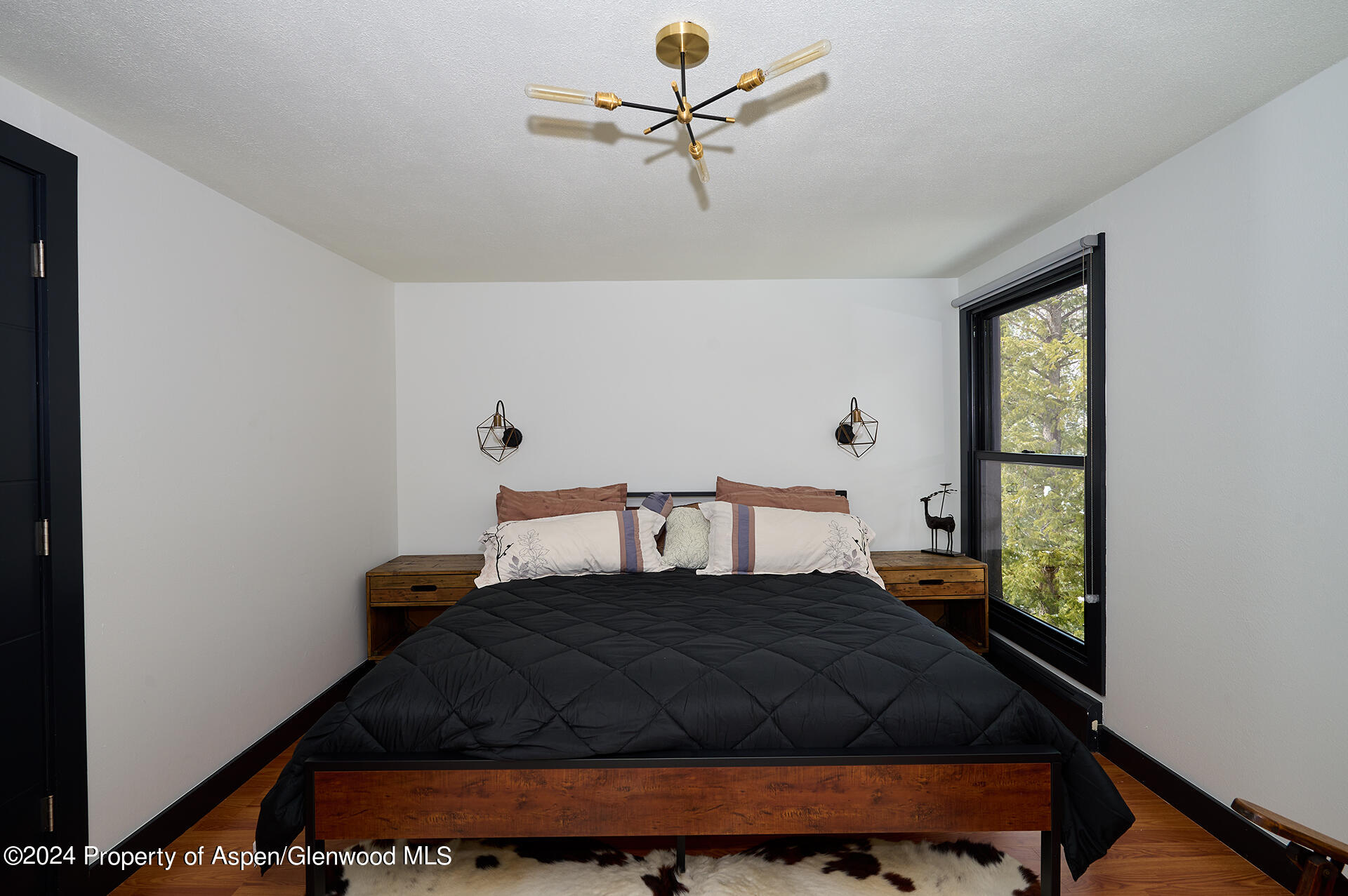 1501 Maroon Creek Road, Unit 6 Aspen, CO 81611 - Photo 11 of 48 a bedroom with a bed and window