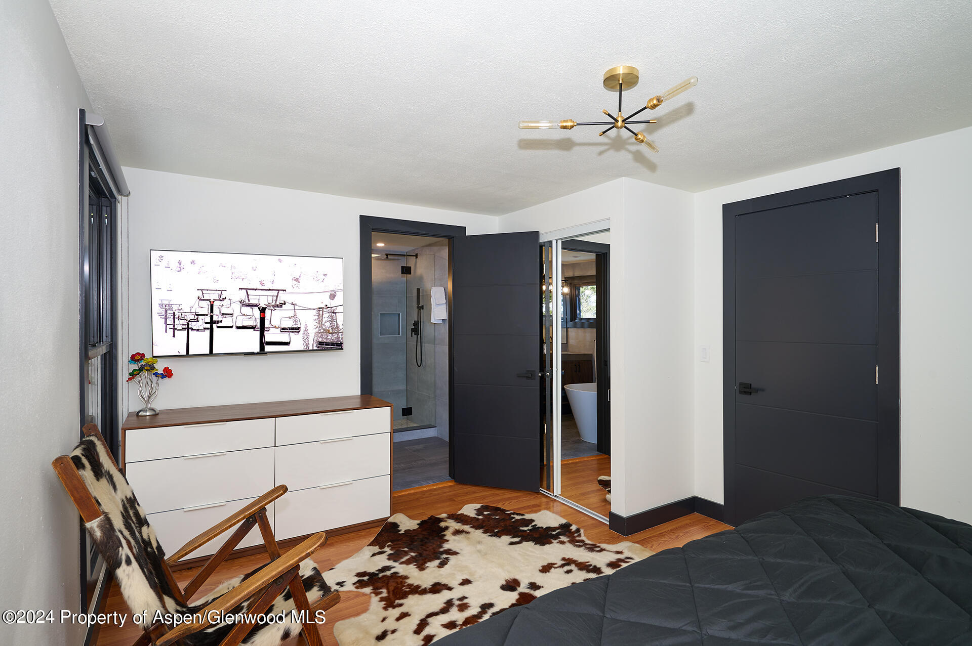 1501 Maroon Creek Road, Unit 6 Aspen, CO 81611 - Photo 12 of 48 a living room with a black white checkered floor with a chandelier