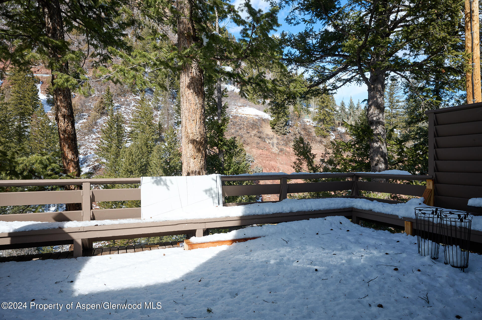 1501 Maroon Creek Road, Unit 6 Aspen, CO 81611 - Photo 15 of 48 a view of a roof deck with couches and wooden fence