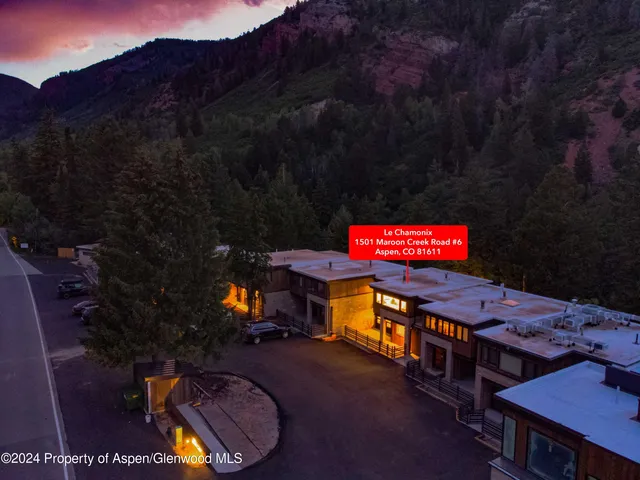 a view of a chairs and table in a backyard
