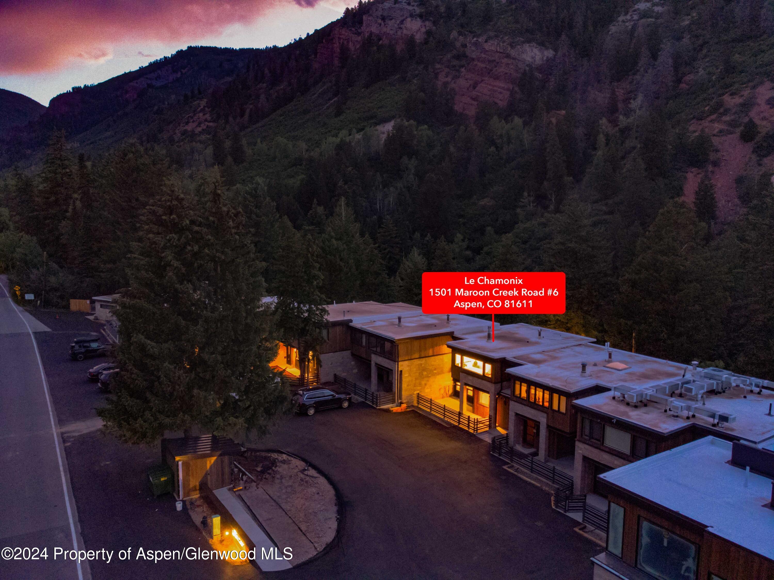 1501 Maroon Creek Road, Unit 6 Aspen, CO 81611 - Photo 17 of 48 a view of a chairs and table in a backyard