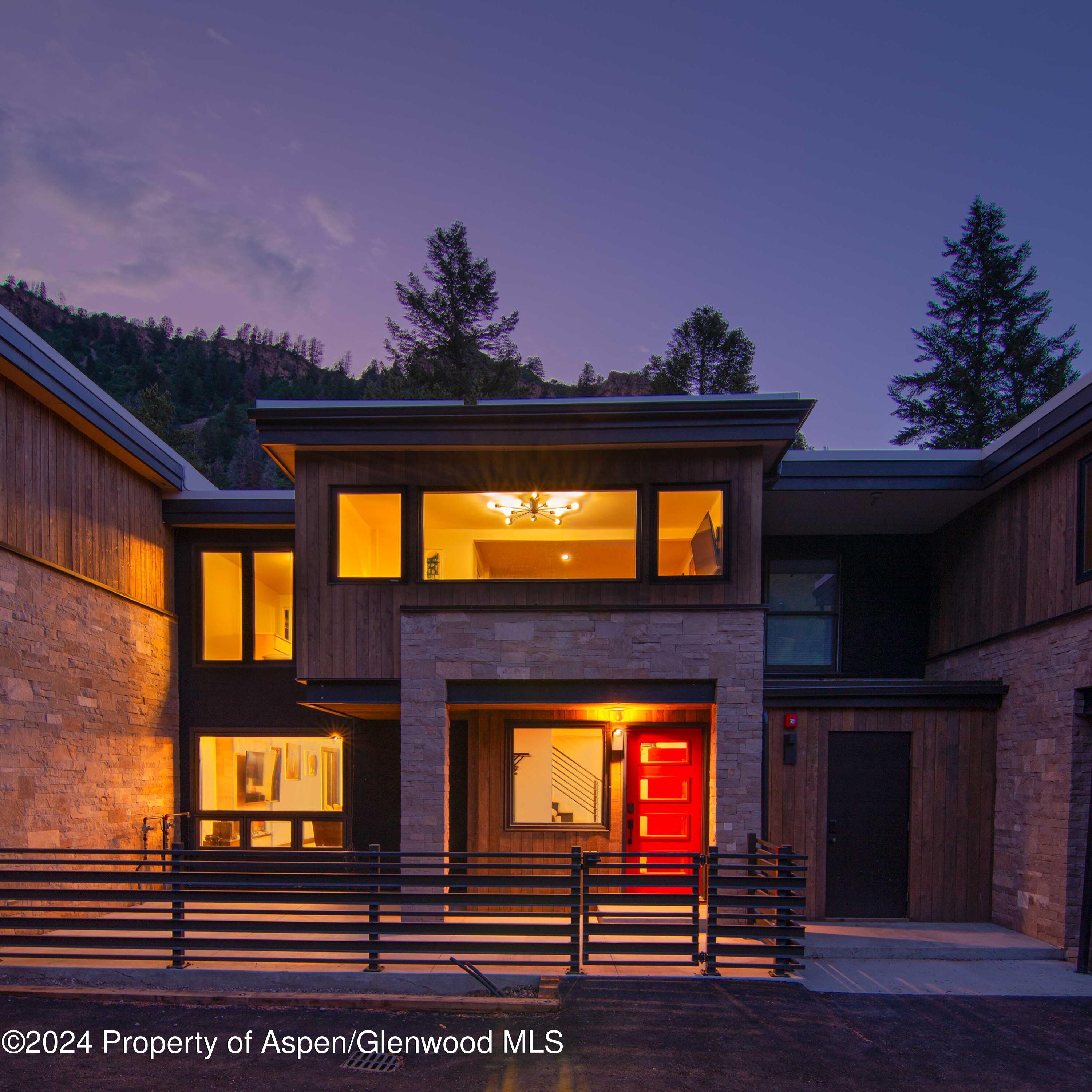 1501 Maroon Creek Road, Unit 6 Aspen, CO 81611 - Photo 23 of 48 a front view of a house with a yard