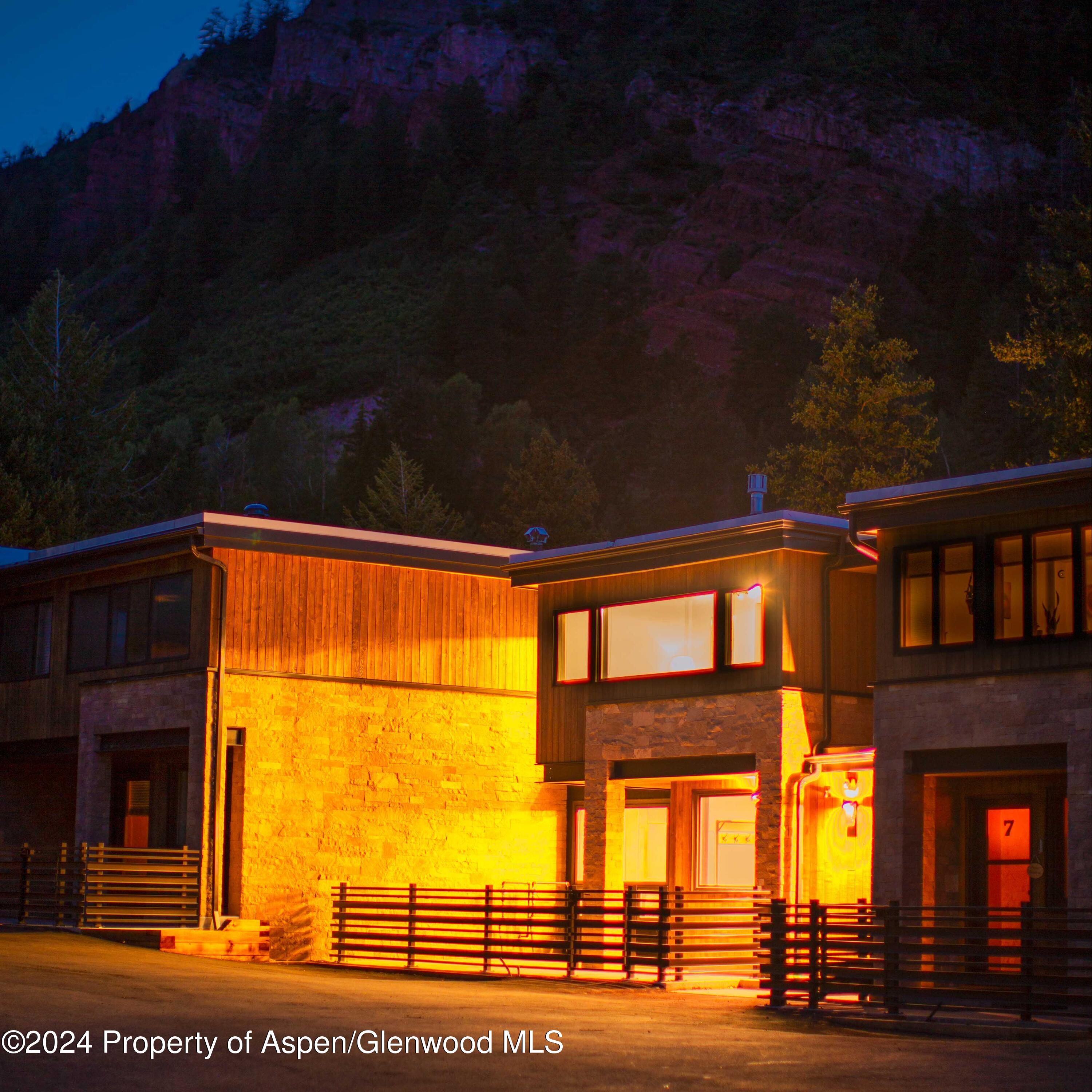 1501 Maroon Creek Road, Unit 6 Aspen, CO 81611 - Photo 27 of 48 a view of building with a yard