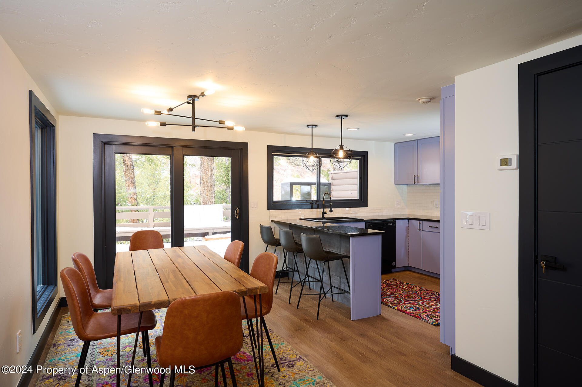 1501 Maroon Creek Road, Unit 6 Aspen, CO 81611 - Photo 4 of 48 a view of a dining room with furniture and wooden floor