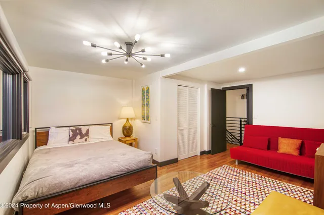 a bedroom with a bed and a couch