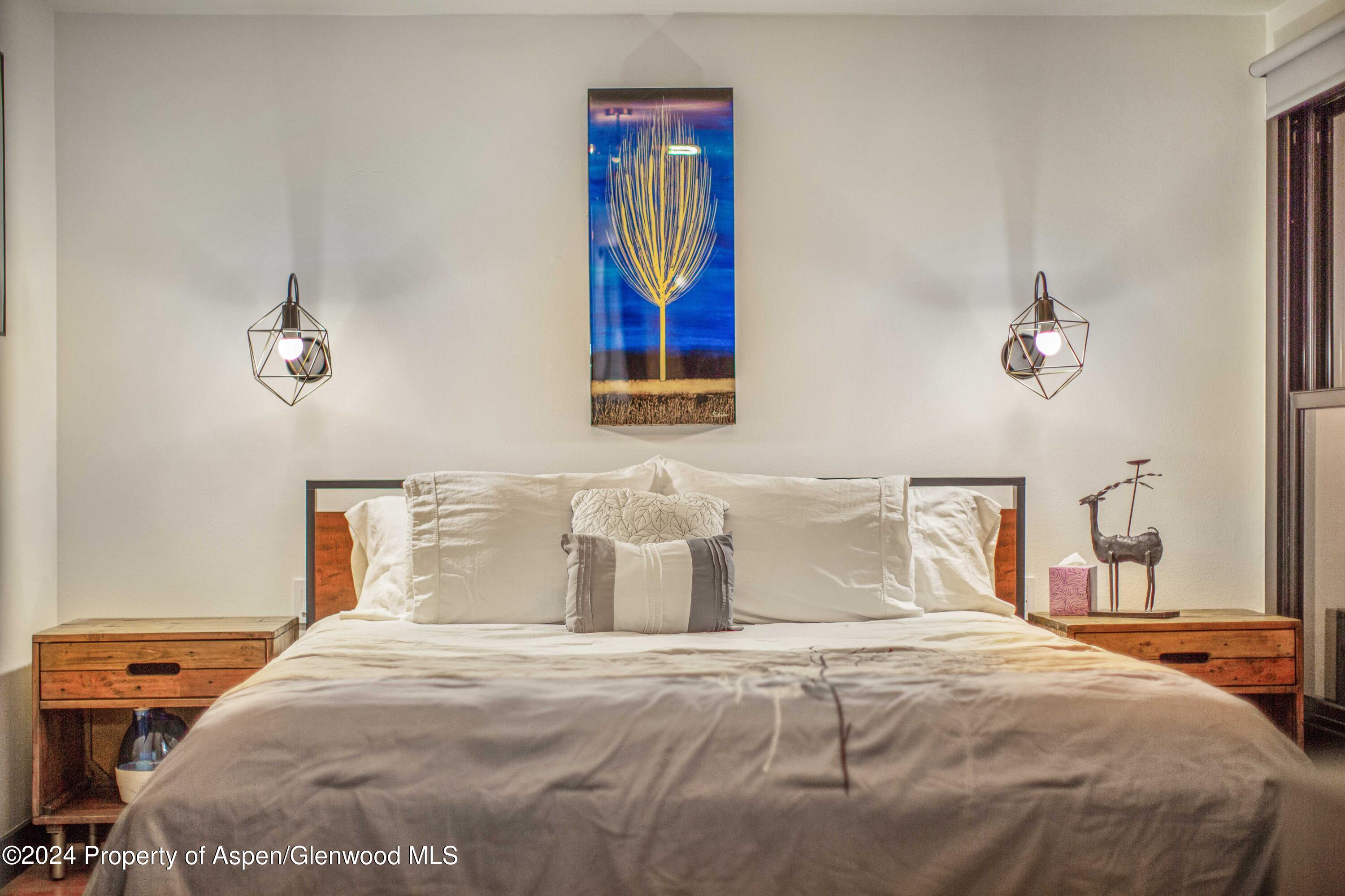 1501 Maroon Creek Road, Unit 6 Aspen, CO 81611 - Photo 48 of 48 a bedroom with a bed and painting on the wall