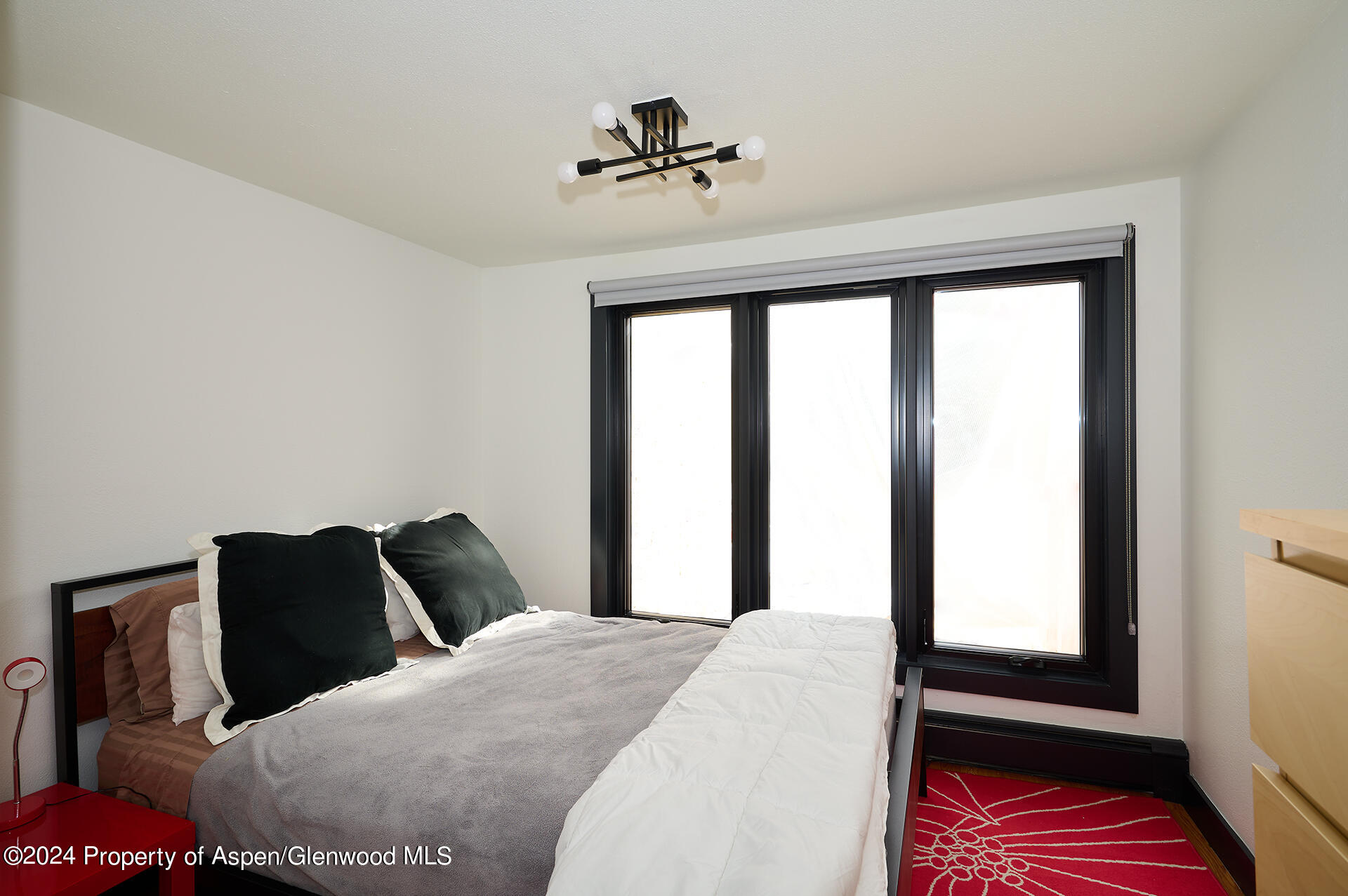 1501 Maroon Creek Road, Unit 6 Aspen, CO 81611 - Photo 10 of 48 a bedroom with a bed and a window