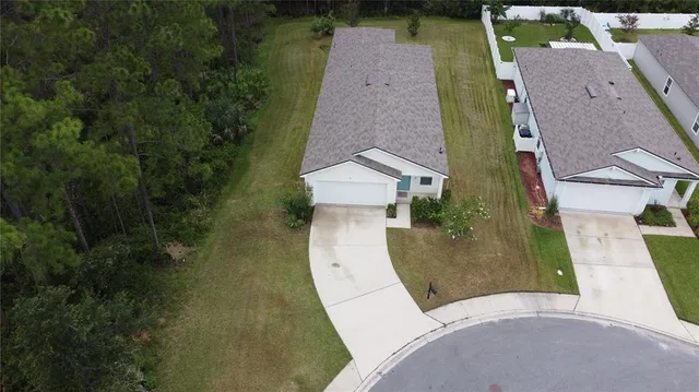 a view of a backyard with swimming pool and sitting area