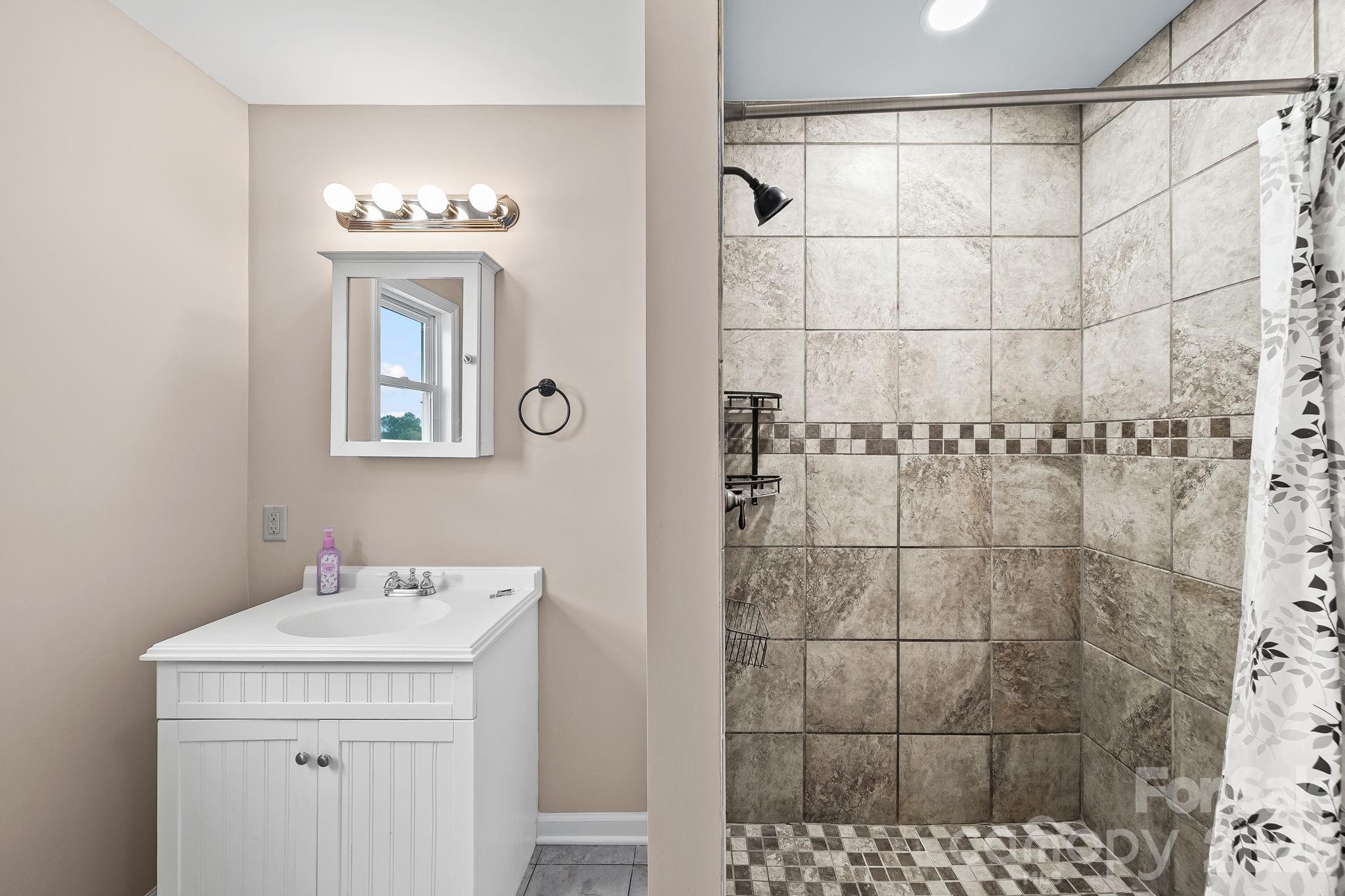 1090 Davids Chapel Church Road Vale, NC 28168 - Photo 11 of 35 a bathroom with a sink a light fixture and a mirror