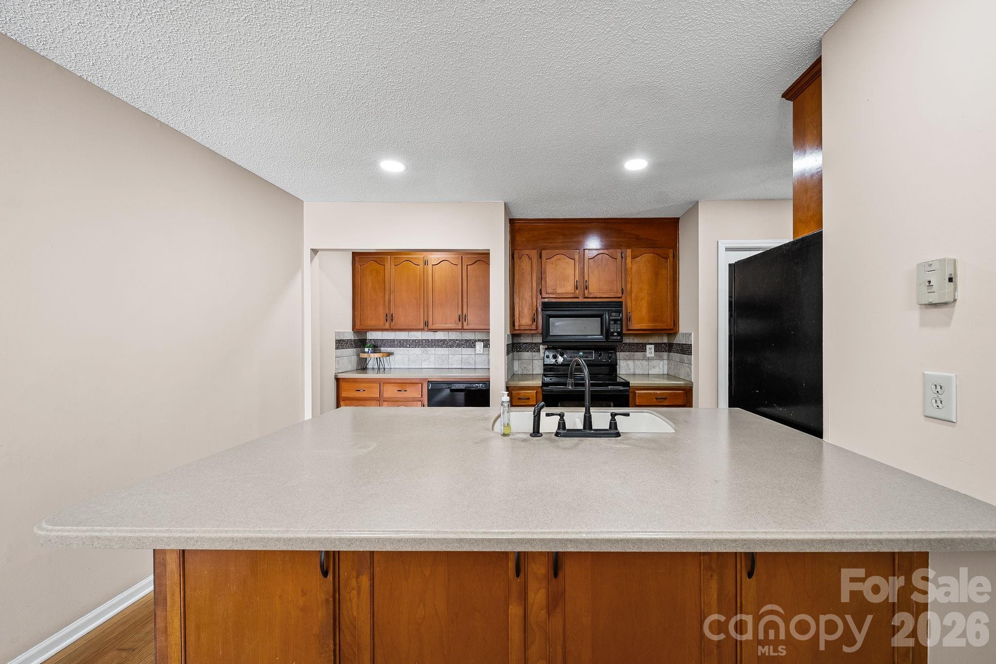 1090 Davids Chapel Church Road Vale, NC 28168 - Photo 22 of 35 a kitchen with stainless steel appliances a refrigerator counter tops and white cabinets