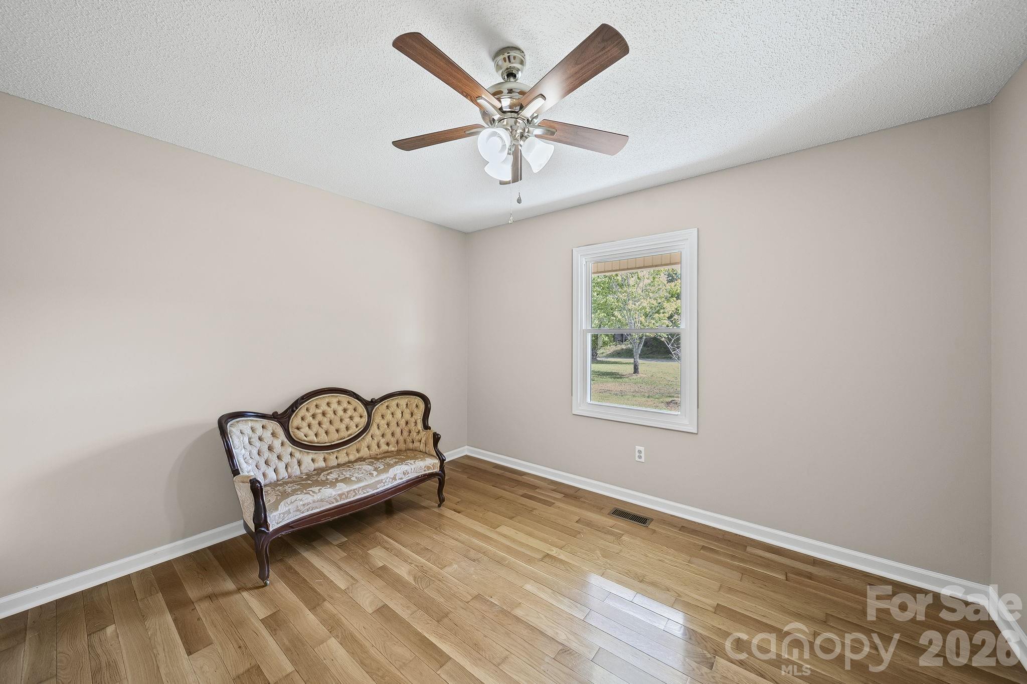 1090 Davids Chapel Church Road Vale, NC 28168 - Photo 25 of 35 an empty room with ceiling fan and windows