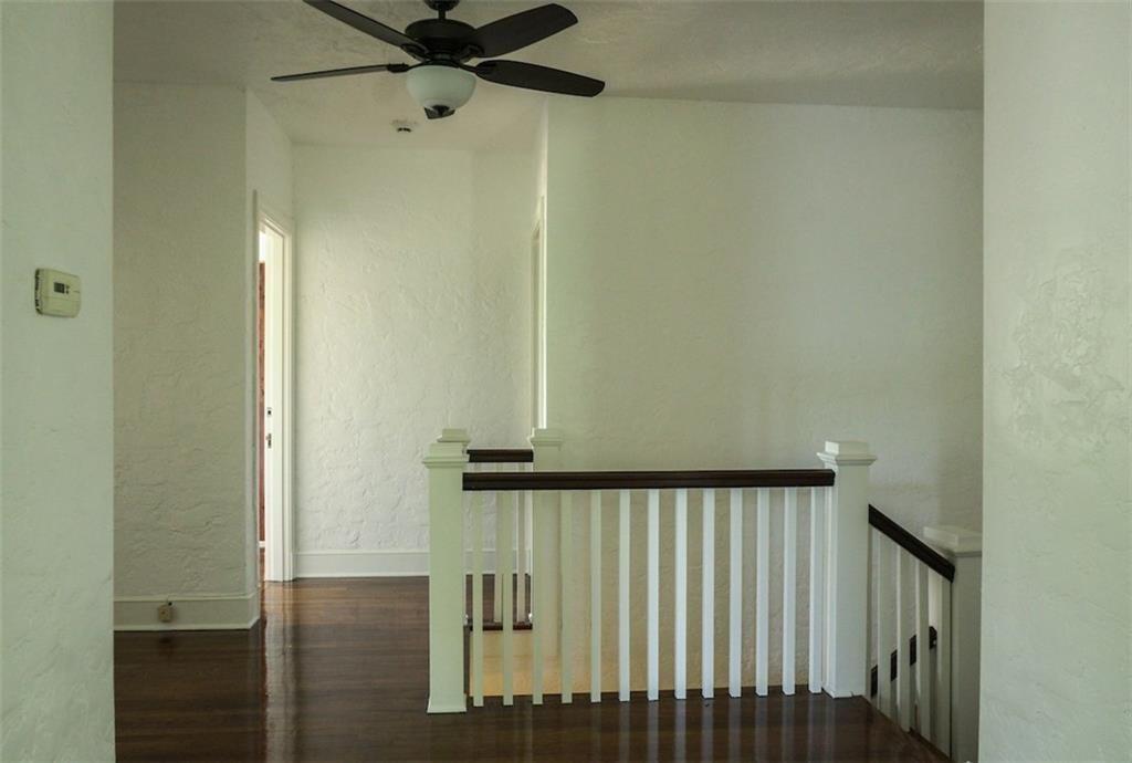 2301 Enfield Road Austin, TX 78703 - Photo 12 of 27 Stairs with a textured wall, wood finished floors, and a ceiling fan