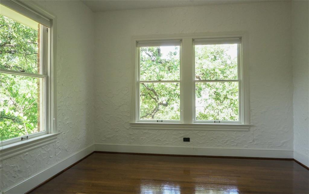 2301 Enfield Road Austin, TX 78703 - Photo 14 of 27 Spare room featuring a textured wall, dark wood finished floors, and healthy amount of natural light