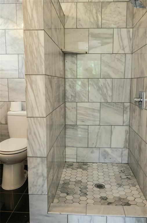 2301 Enfield Road Austin, TX 78703 - Photo 20 of 27 Bathroom featuring a stall shower and tile walls
