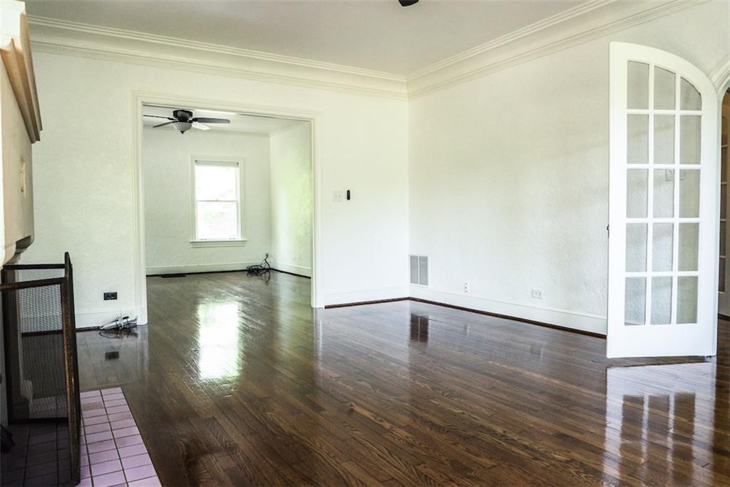 2301 Enfield Road Austin, TX 78703 - Photo 2 of 27 Unfurnished room featuring dark wood finished floors, ornamental molding, and a ceiling fan