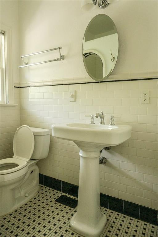 2301 Enfield Road Austin, TX 78703 - Photo 22 of 27 Bathroom with tile walls, a wainscoted wall, and tile patterned floors