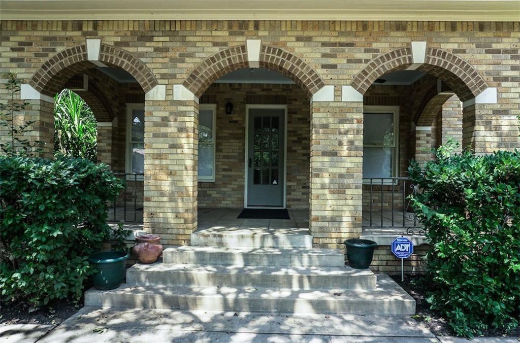 2301 Enfield Road Austin, TX 78703 - Photo 24 of 27 Doorway to property with covered porch and brick siding