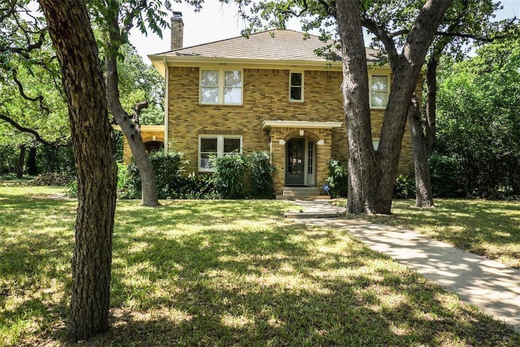 2301 Enfield Road Austin, TX 78703 - Photo 27 of 27 View of front of home featuring a front yard, brick siding, and a chimney