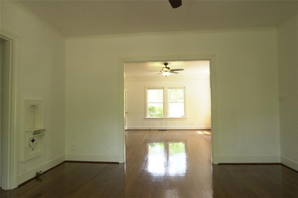 2301 Enfield Road Austin, TX 78703 - Photo 9 of 27 Unfurnished room featuring dark wood-style flooring, crown molding, and a ceiling fan