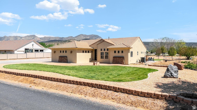 7776 Wagon Road East St. George, UT 84770 - Photo 2 of 76 View of front of home featuring stucco siding and a mountain view