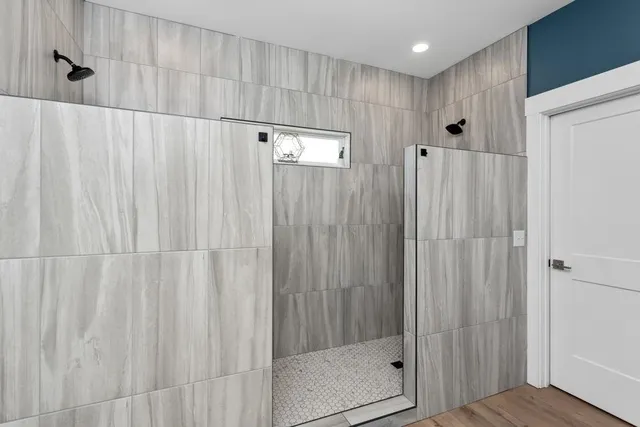 a bathroom with a shower and a tub