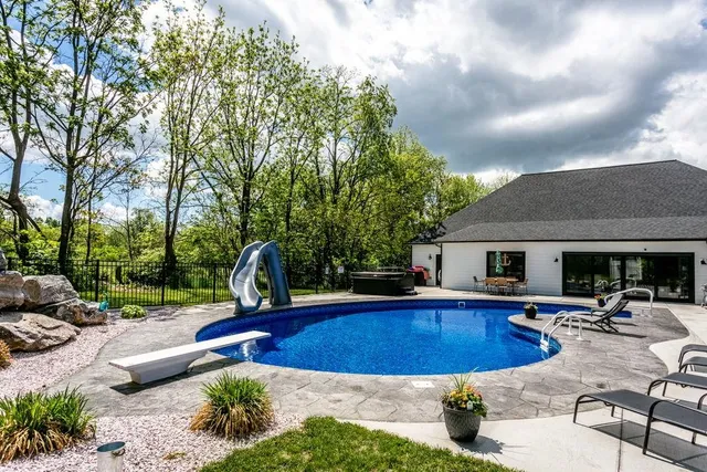 a view of a red yard with red and white house